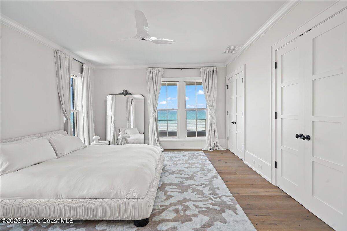 5525 Jimmy Buffett Mem Highway Melbourne Beach, FL 32951 - Photo 29 of 56 a spacious bedroom with a large bed and a walk in closet