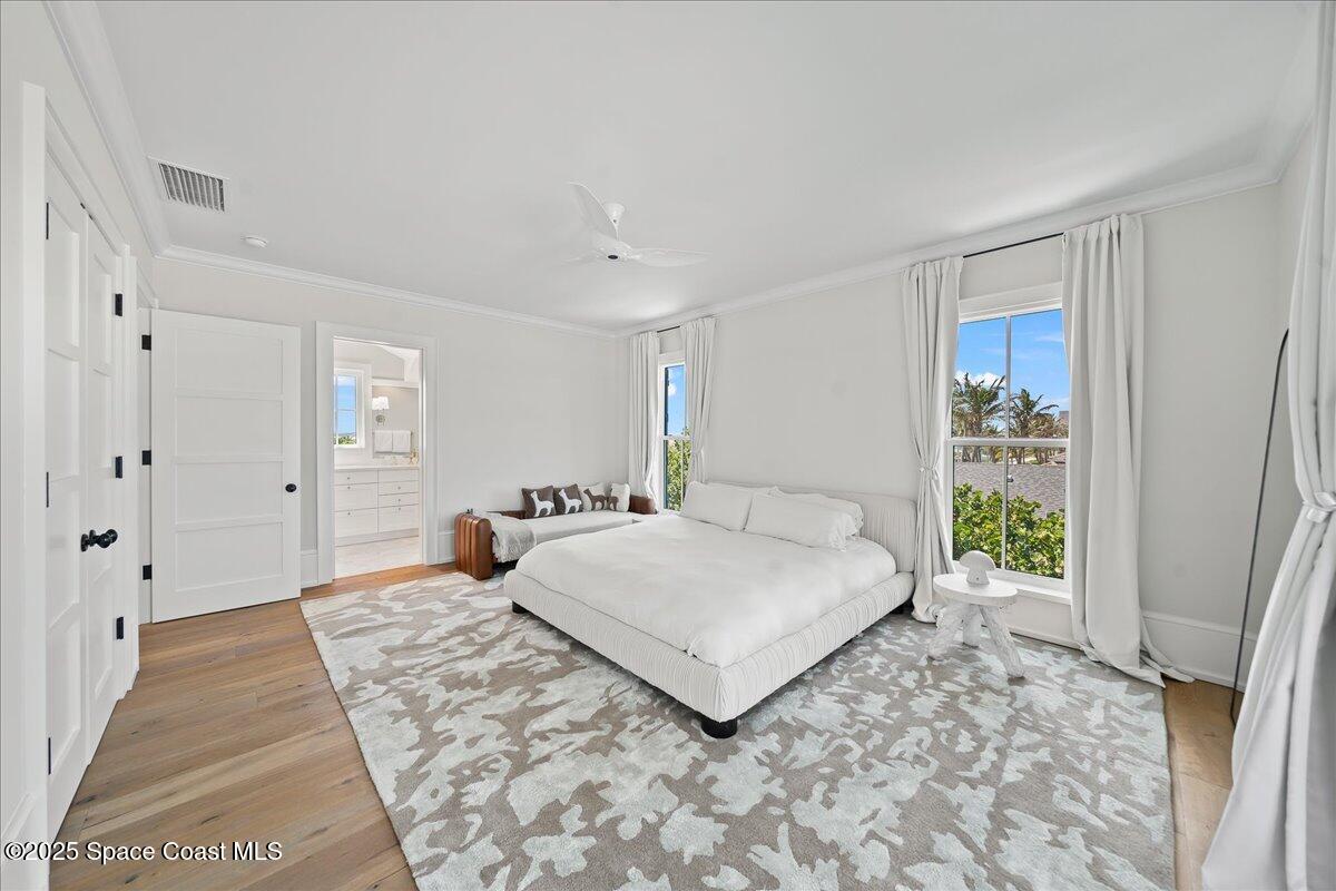 5525 Jimmy Buffett Mem Highway Melbourne Beach, FL 32951 - Photo 30 of 56 a bedroom with a large bed and a window