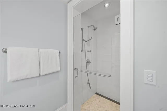 a bedroom with furniture and a large window