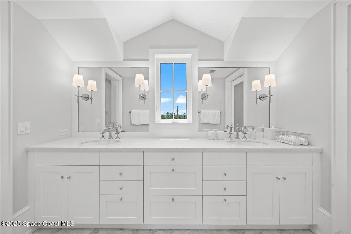 5525 Jimmy Buffett Mem Highway Melbourne Beach, FL 32951 - Photo 32 of 56 a bathroom with a double vanity sink and mirror
