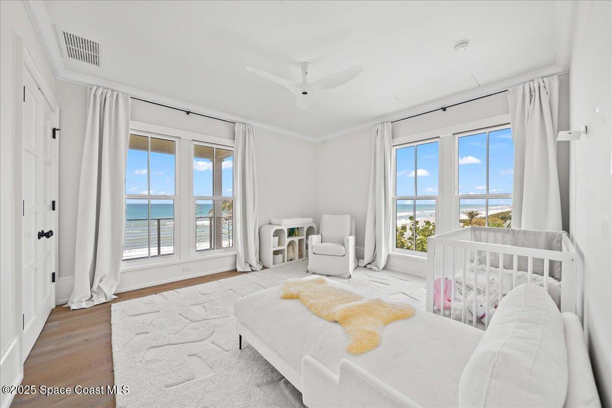 5525 Jimmy Buffett Mem Highway Melbourne Beach, FL 32951 - Photo 35 of 56 a bedroom with furniture and a large window