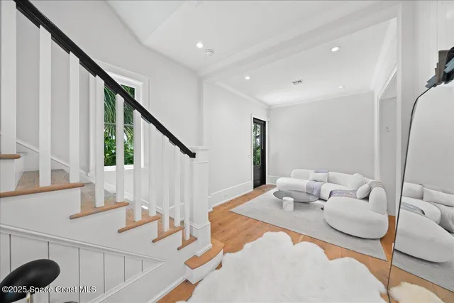 a view of entryway and hall with wooden floor