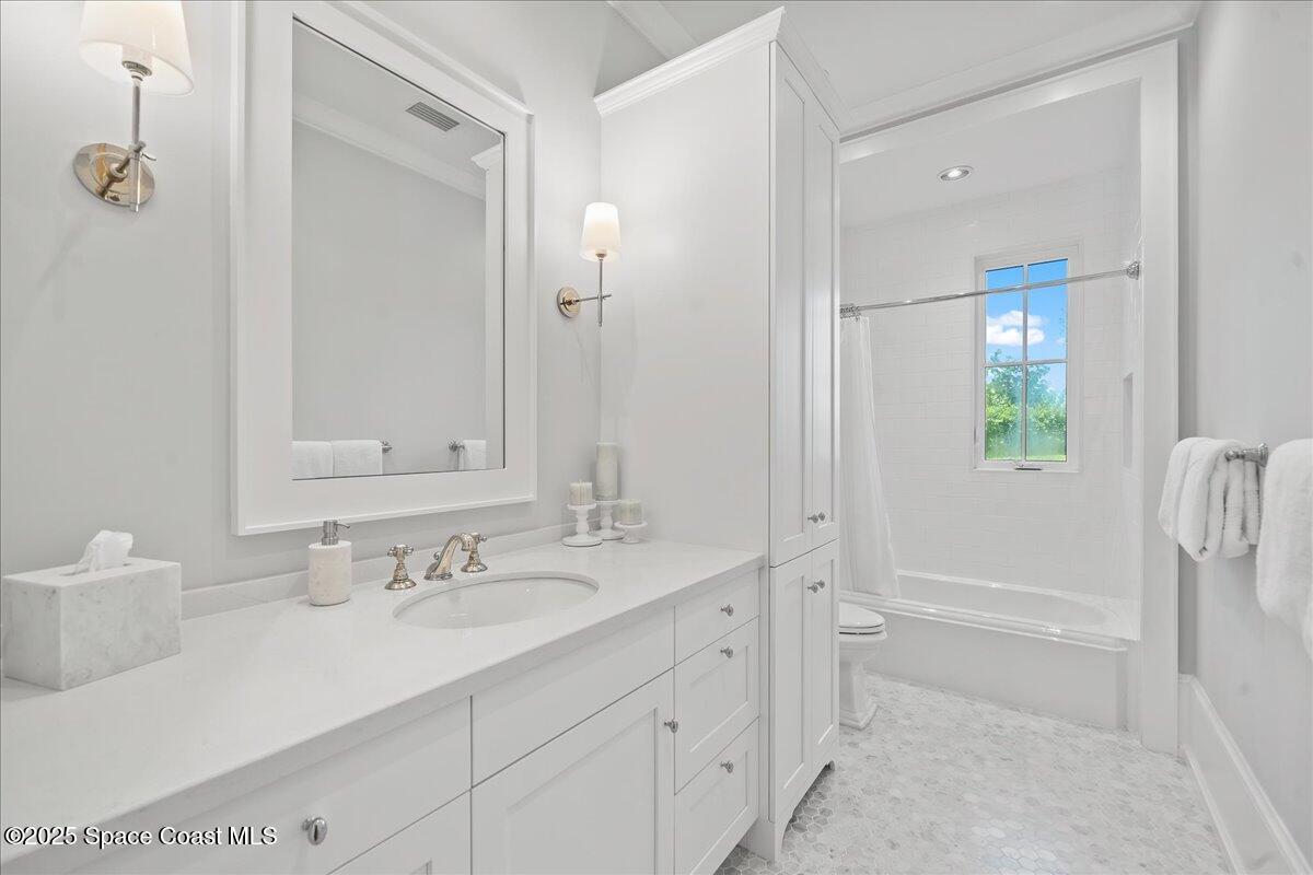 5525 Jimmy Buffett Mem Highway Melbourne Beach, FL 32951 - Photo 39 of 56 a bathroom with a sink and a mirror
