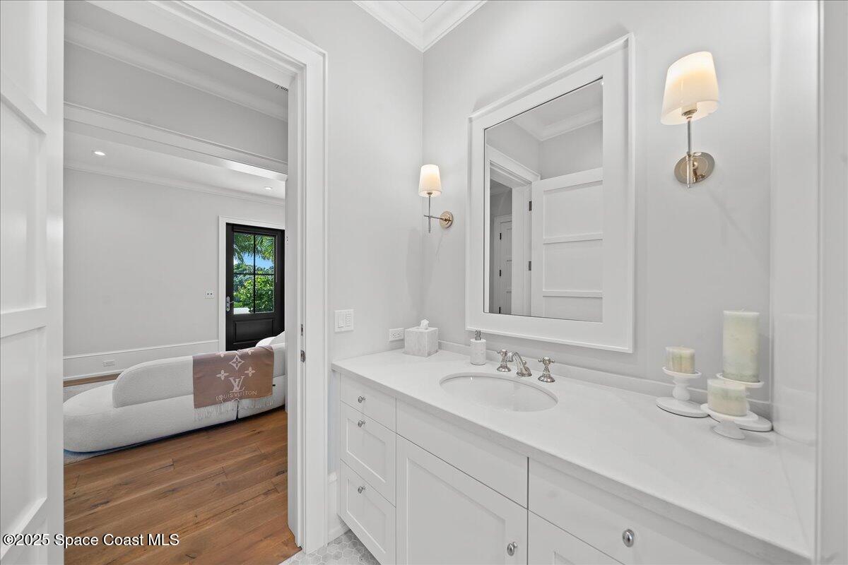 5525 Jimmy Buffett Mem Highway Melbourne Beach, FL 32951 - Photo 40 of 56 a en suite bathroom with a granite countertop tub sink and mirror
