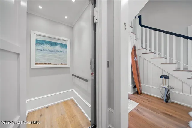 a view of a building with a yard and coconut trees