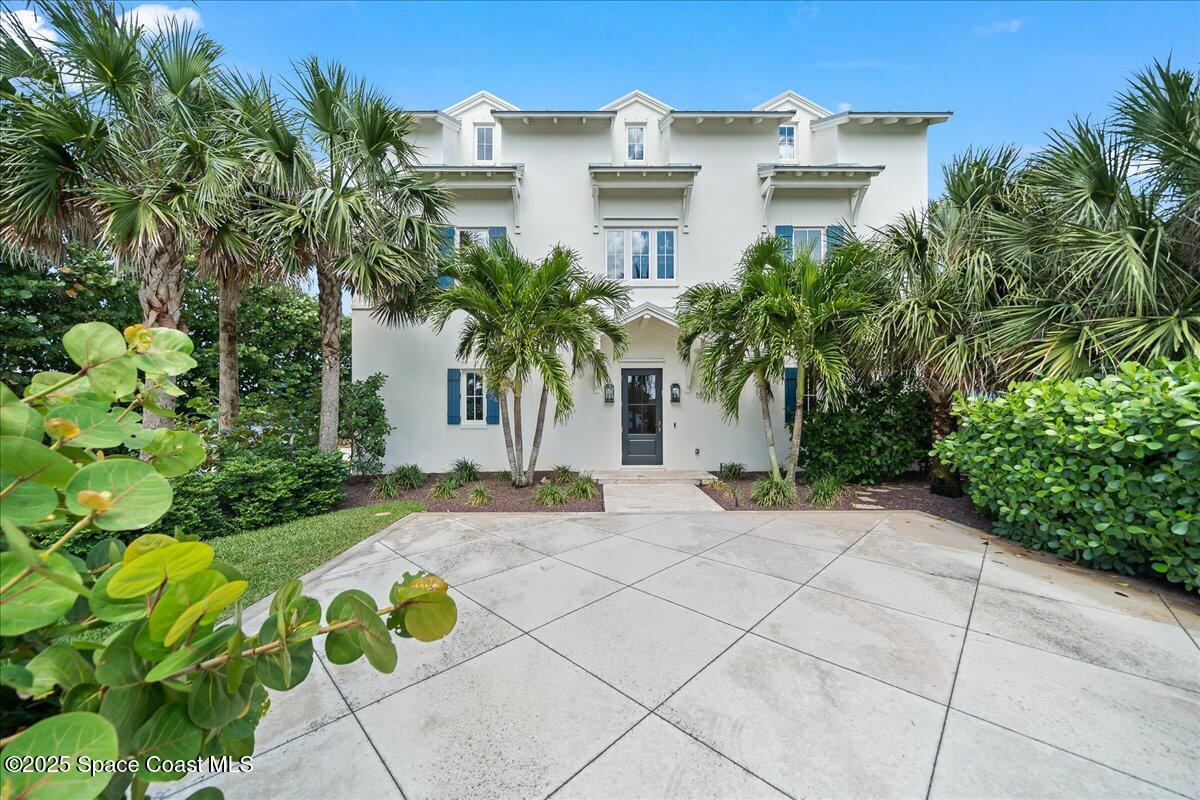 5525 Jimmy Buffett Mem Highway Melbourne Beach, FL 32951 - Photo 48 of 56 a view of a building with a yard and coconut trees