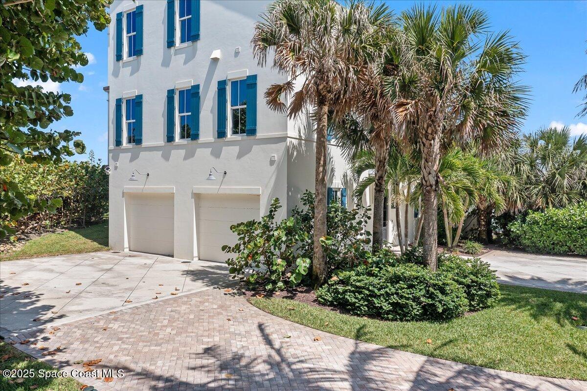 5525 Jimmy Buffett Mem Highway Melbourne Beach, FL 32951 - Photo 50 of 56 a front view of a house with a garden