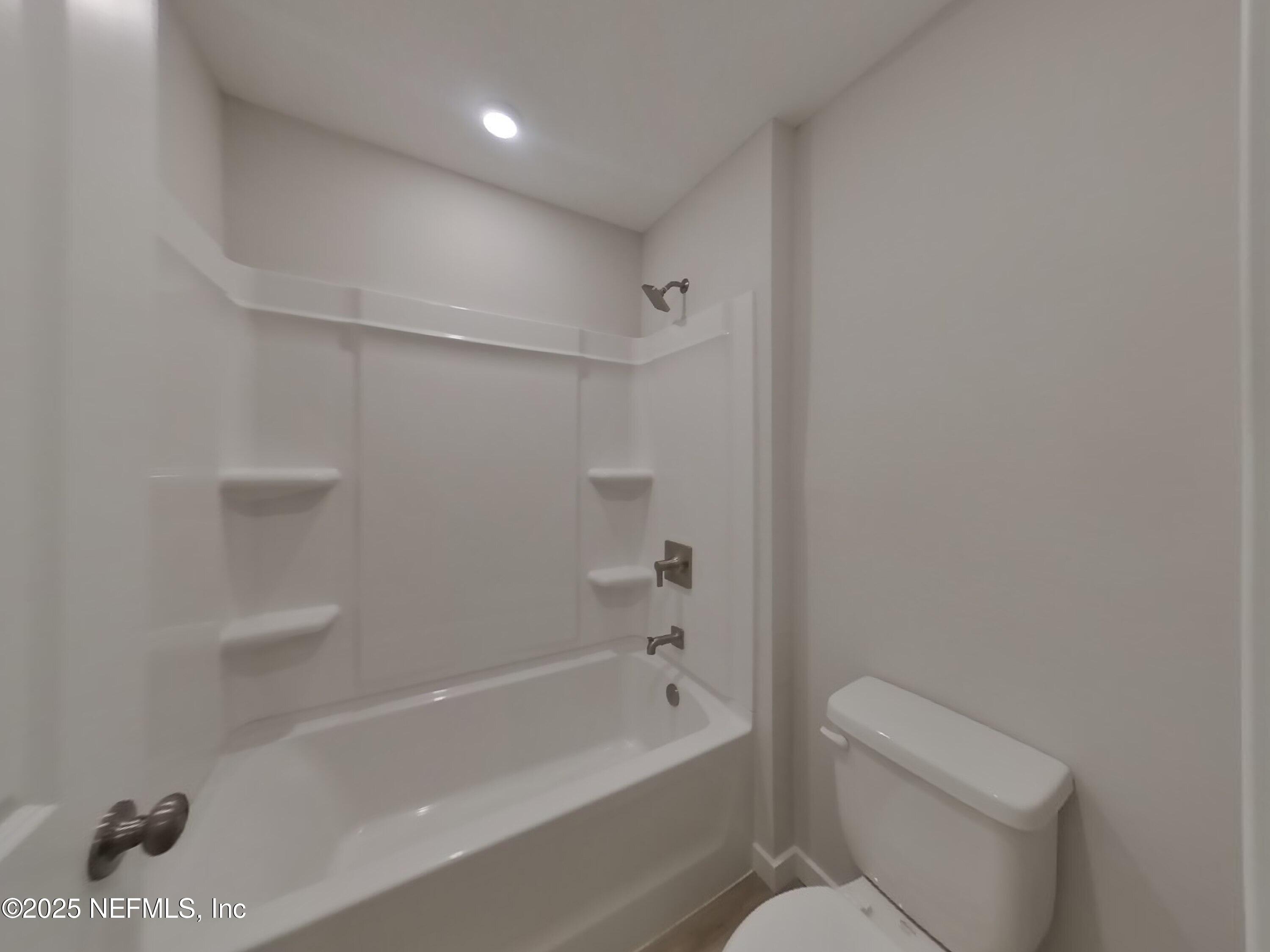 14897 Praline Court Jacksonville, FL 32218 - Photo 13 of 17 a bathroom with a bathtub and a toilet