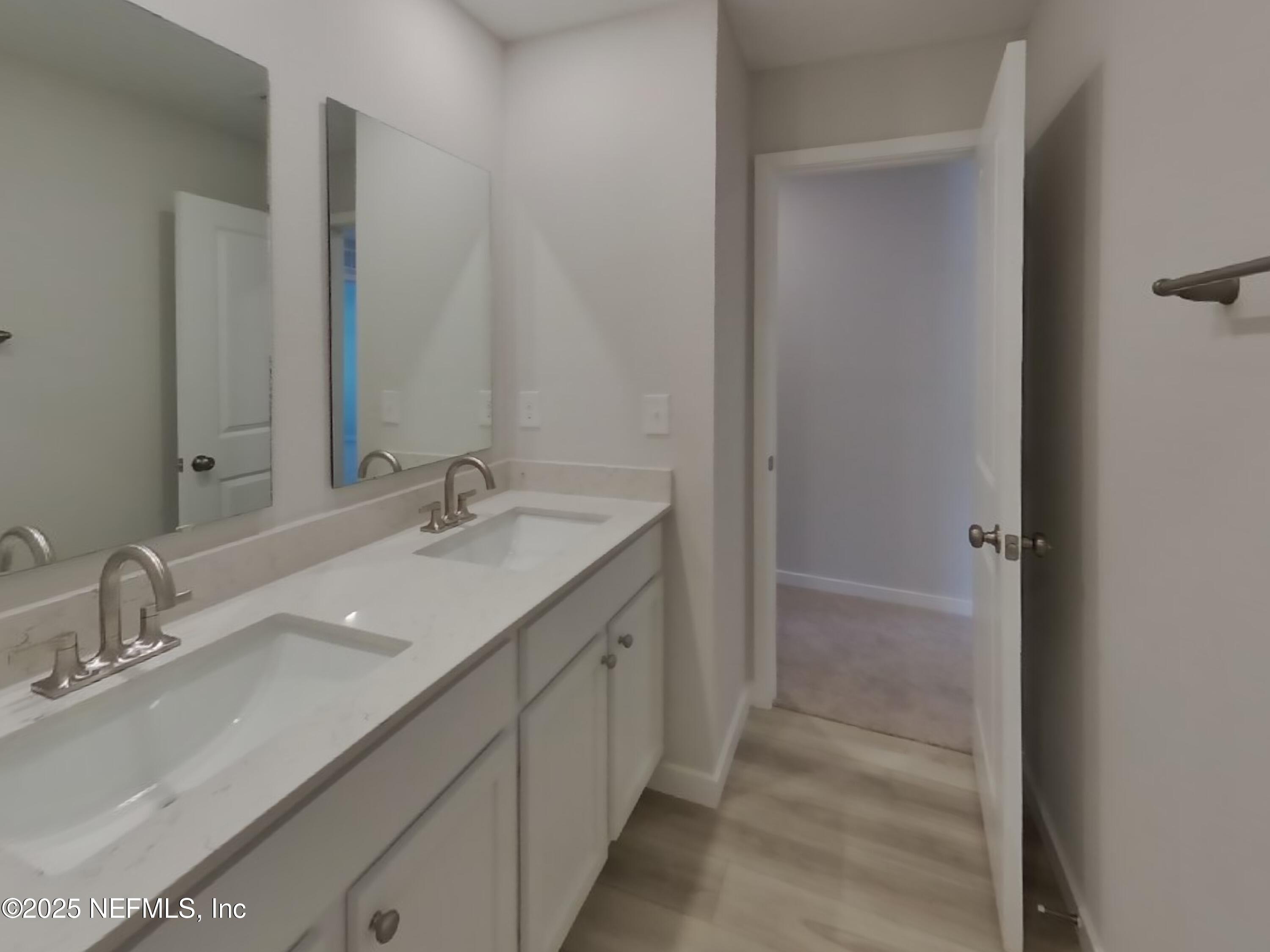 14897 Praline Court Jacksonville, FL 32218 - Photo 14 of 17 a bathroom with a double vanity sink and a mirror