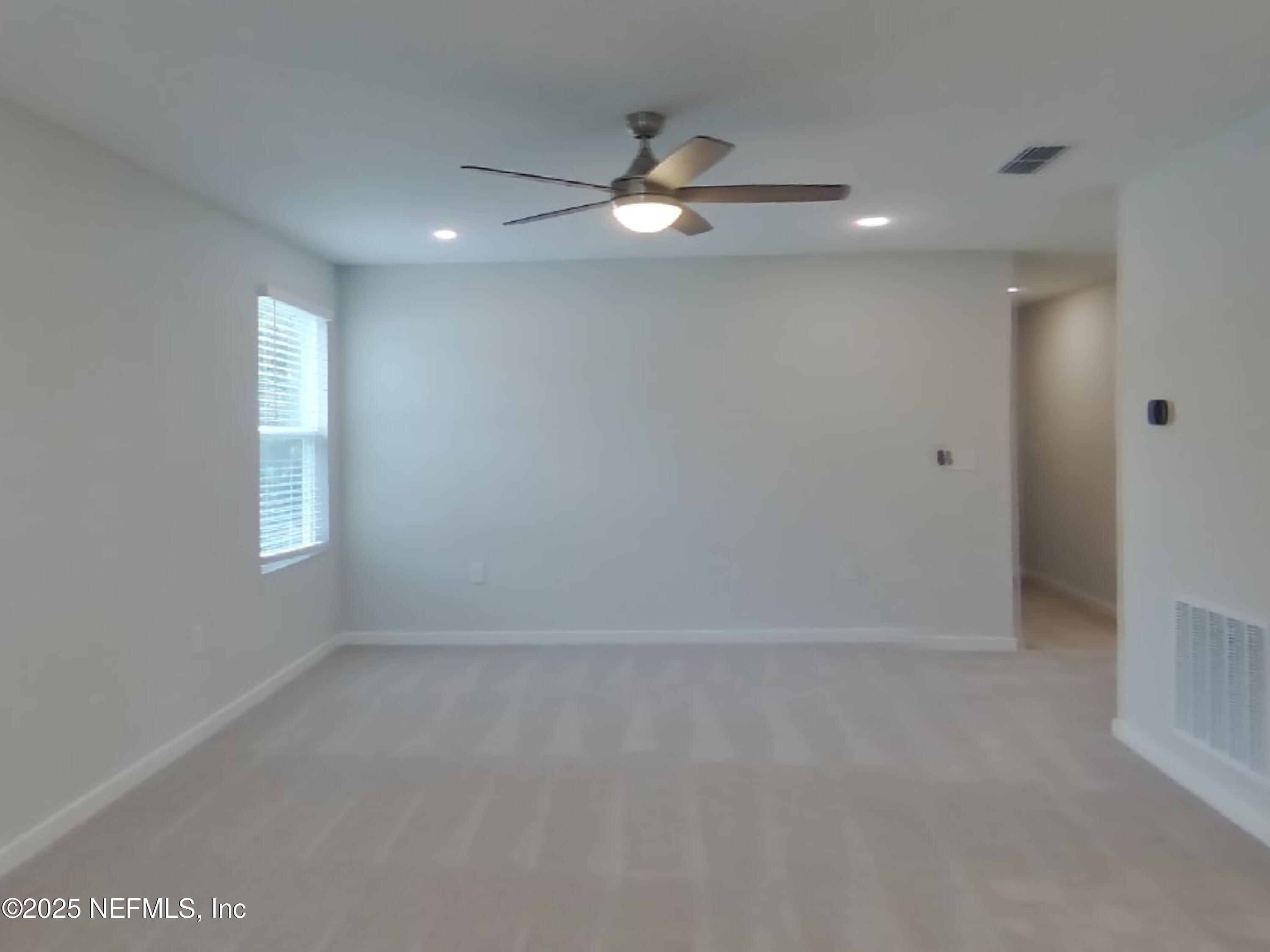 14897 Praline Court Jacksonville, FL 32218 - Photo 15 of 17 an empty room with a ceiling fan and window