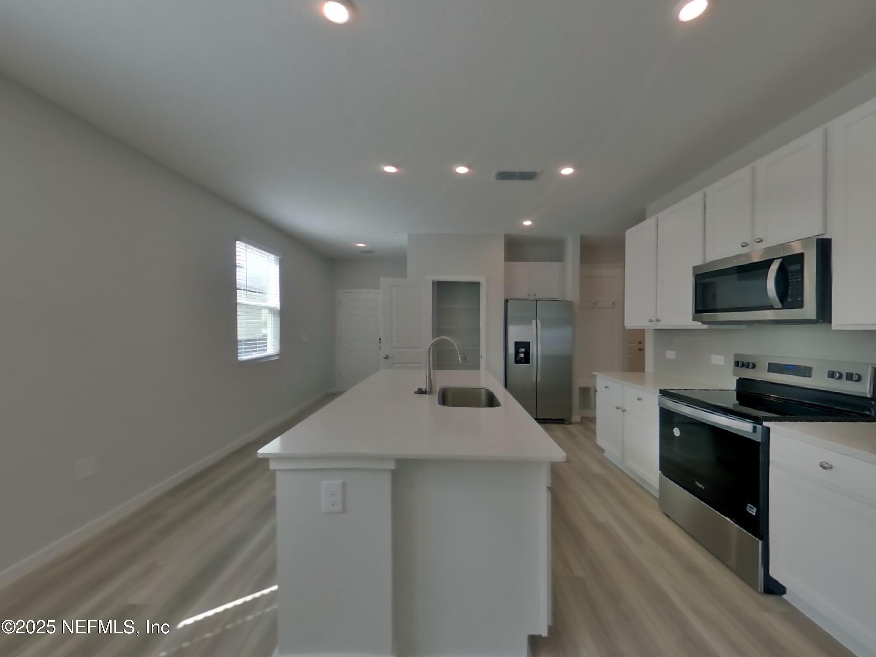 14897 Praline Court Jacksonville, FL 32218 - Photo 4 of 17 a kitchen with a sink stainless steel appliances and cabinets