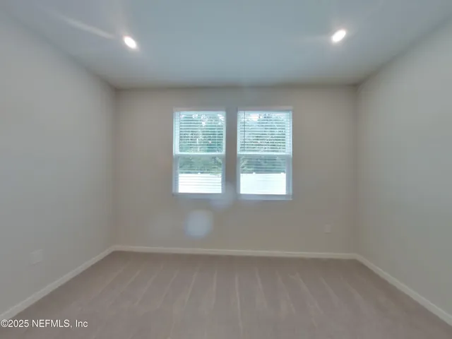 a spacious bathroom with a double vanity sink a mirror and a shower