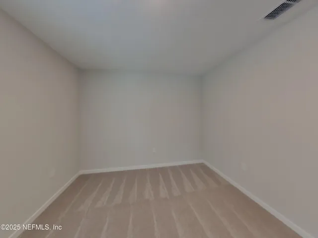 a view of an empty room and a window