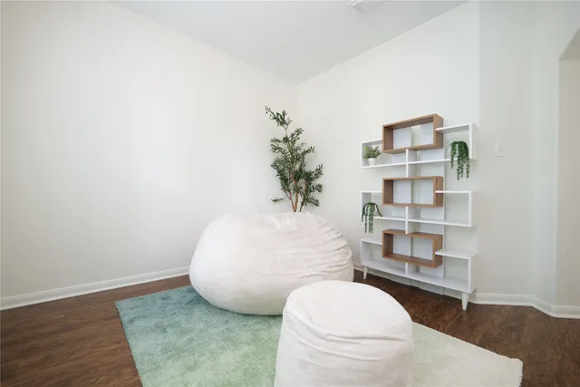 a kitchen with a table chairs refrigerator and cabinets