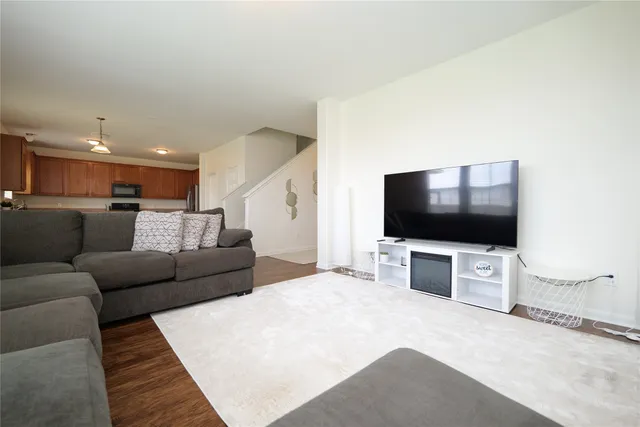 a kitchen with stainless steel appliances granite countertop a refrigerator a sink a stove and a refrigerator