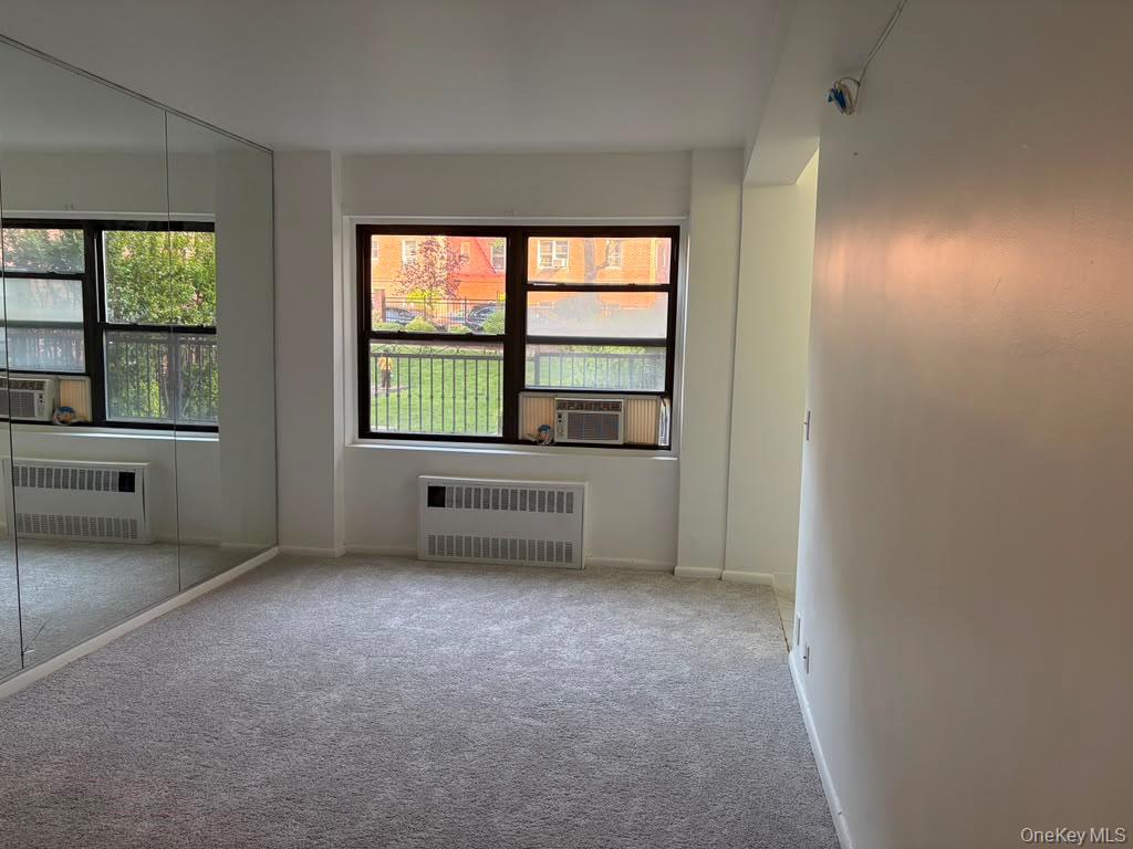 99-60 63rd Road, Unit 1H Queens, NY 11374 - Photo 1 of 11 an empty room with windows