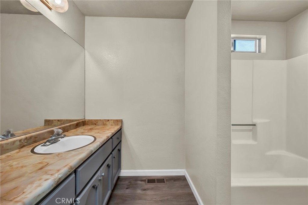 16927 Greenridge Road Hidden Valley Lake, CA 95467 - Photo 13 of 25 a bathroom with a granite countertop sink and a mirror