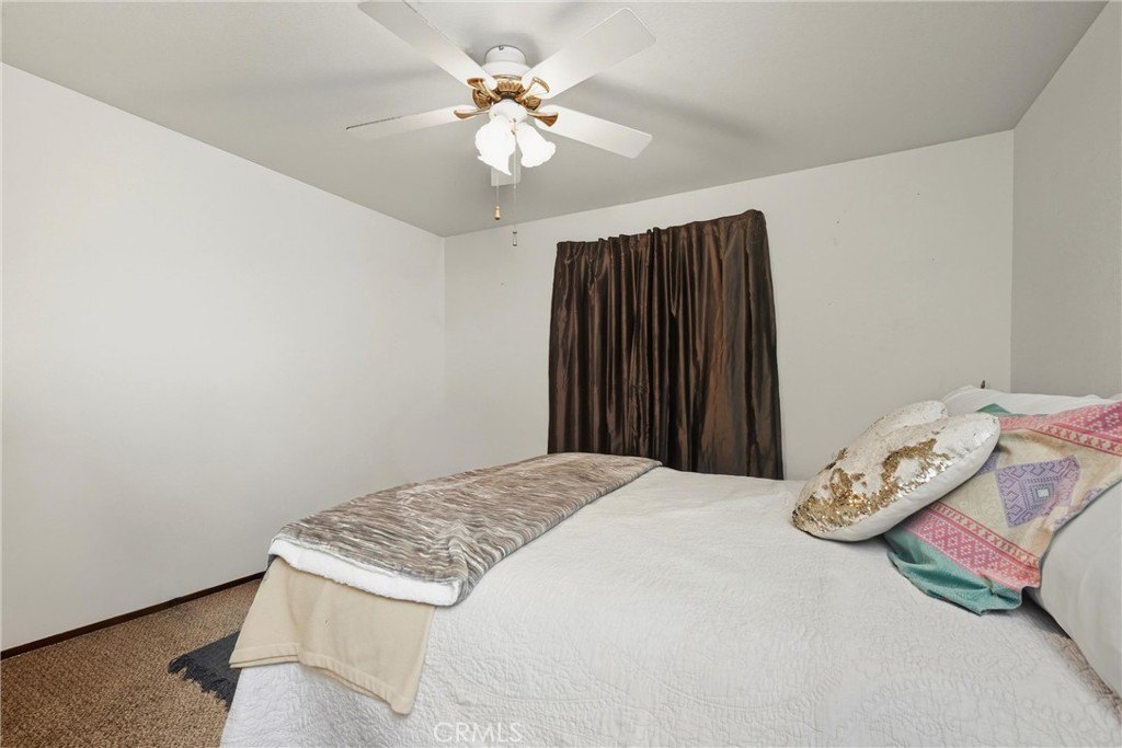16927 Greenridge Road Hidden Valley Lake, CA 95467 - Photo 15 of 25 a bedroom with a bed and a chandelier