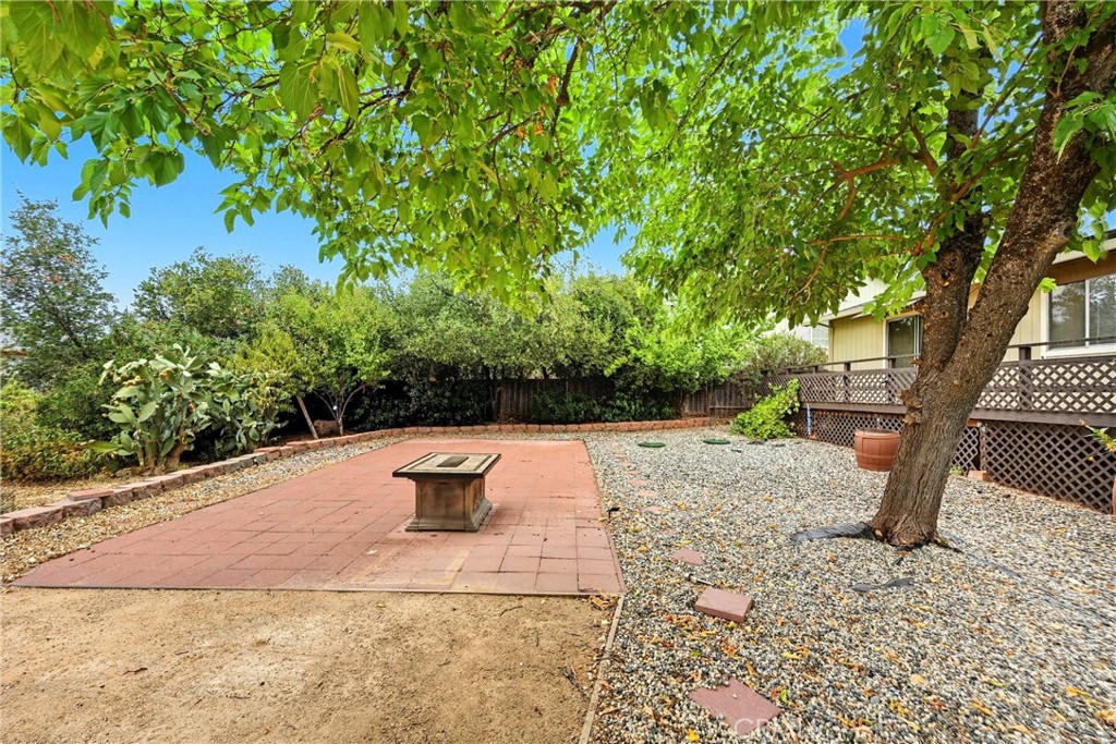 16927 Greenridge Road Hidden Valley Lake, CA 95467 - Photo 22 of 25 a backyard of a house with table and chairs
