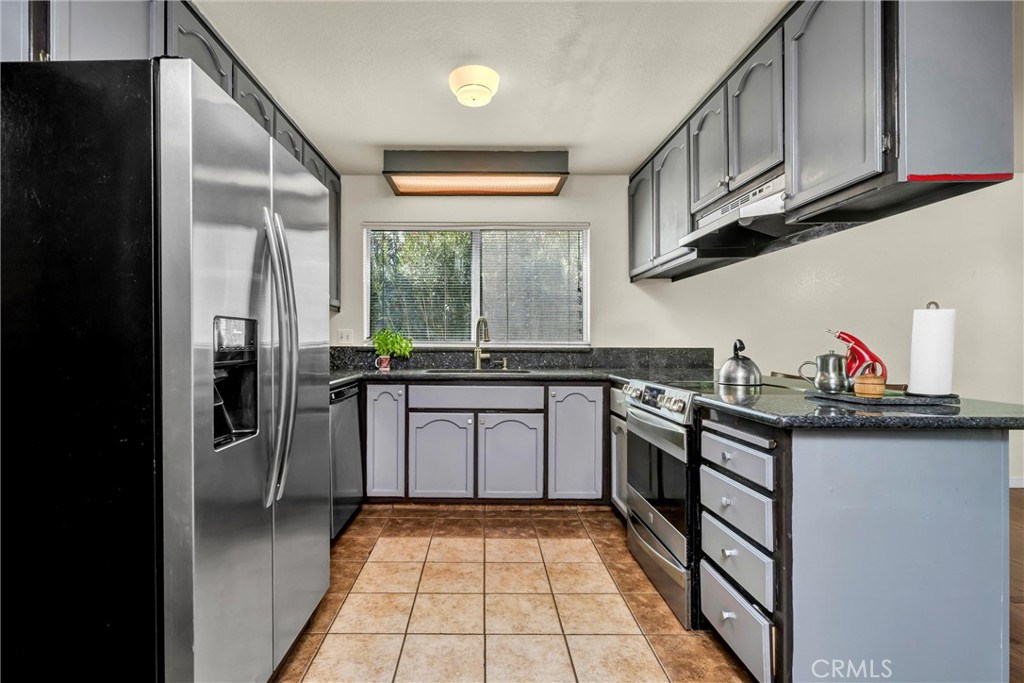 16927 Greenridge Road Hidden Valley Lake, CA 95467 - Photo 6 of 25 a kitchen with stainless steel appliances granite countertop a sink stove and cabinets