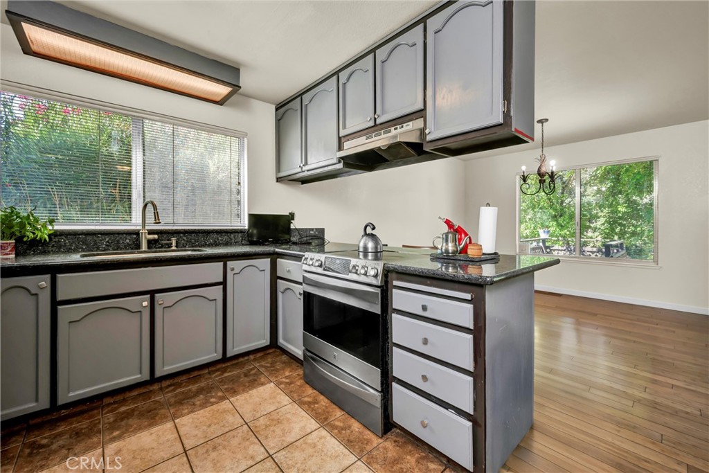 16927 Greenridge Road Hidden Valley Lake, CA 95467 - Photo 7 of 25 a kitchen with stainless steel appliances granite countertop a stove a sink and a microwave