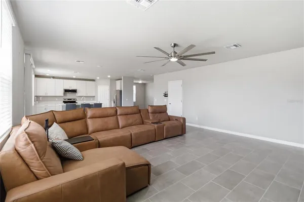 a view of a living room a rug and a ceiling fan