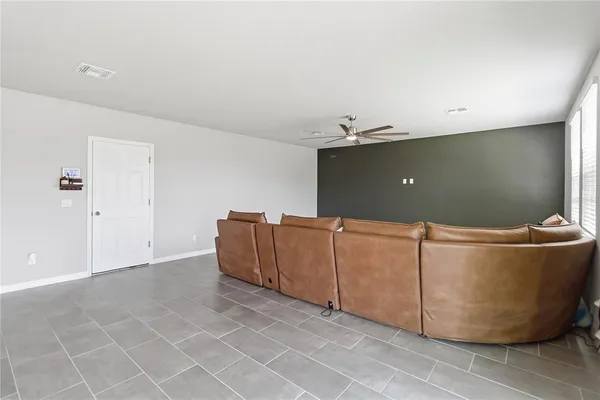 a living room with a couch and a potted plant