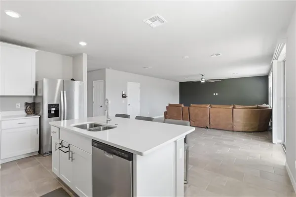 a kitchen that has a lot of cabinets and wooden floor