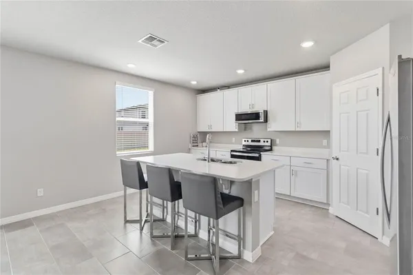a kitchen that has a sink and a stove top oven