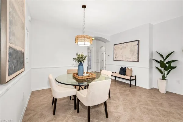a view of a dining room with furniture and a potted plant