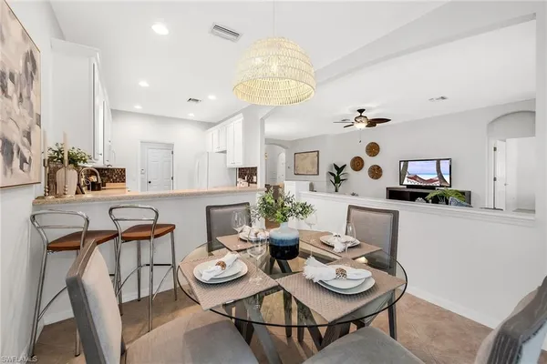 a view of a dining room with furniture and a kitchen