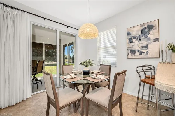 a dining room with furniture and window