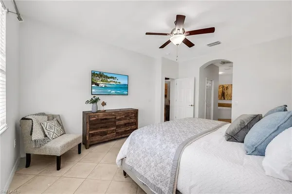 a bedroom with furniture and ceiling fan