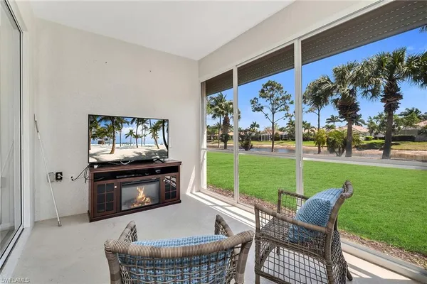 a living room with furniture and a floor to ceiling window