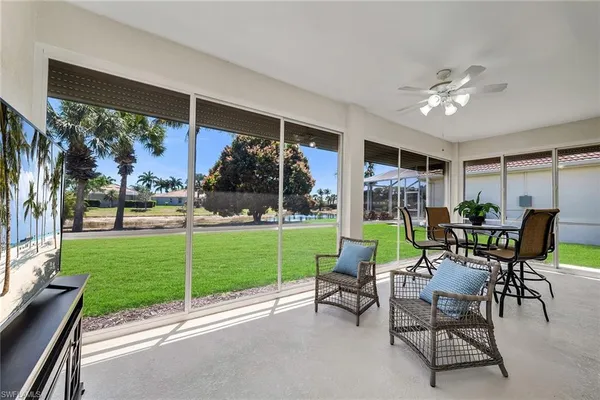a view of a patio with a table chairs and a yard