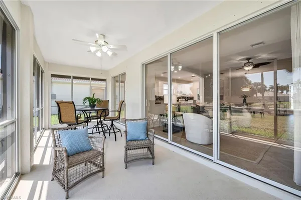 a dining room with furniture and a floor to ceiling window