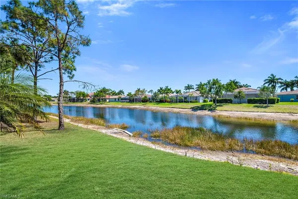 a view of a lake with a house in the background