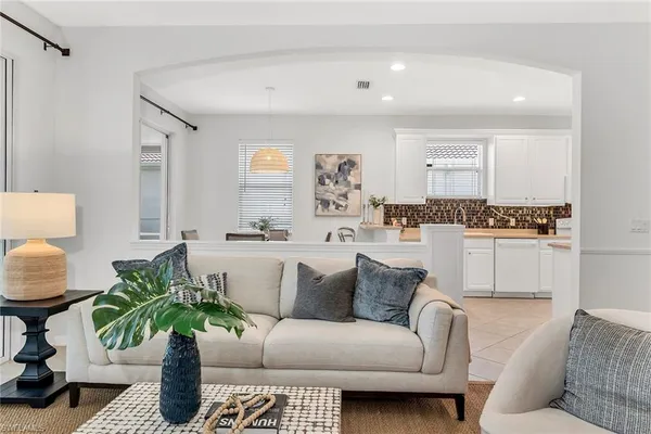 a living room with furniture and a potted plant