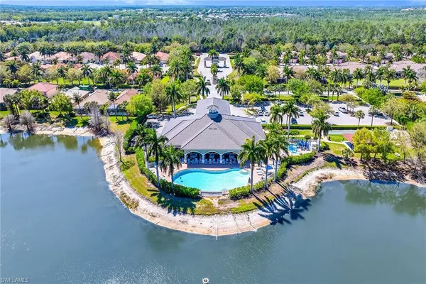 an aerial view of residential houses with outdoor space and lake view