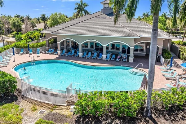 a front view of house and swimming pool with patio