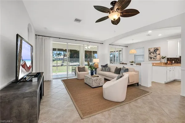 a living room with fireplace furniture and a flat screen tv