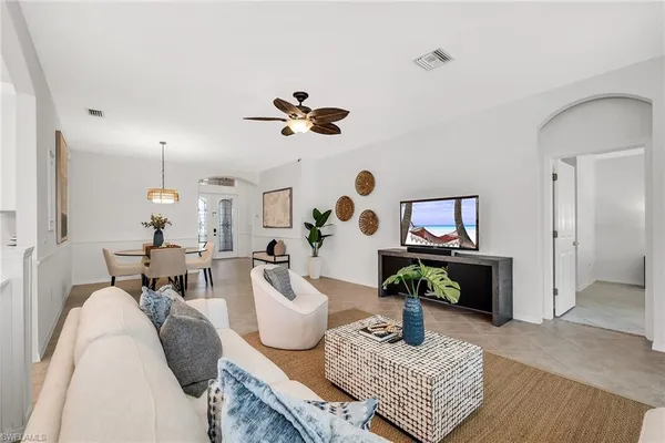 a living room with furniture flowerpot and window
