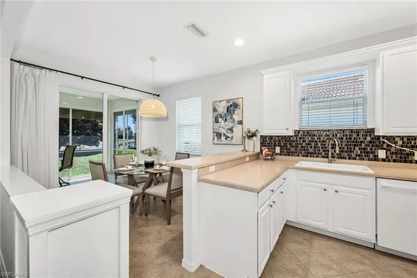 a kitchen that has a sink and a stove in it