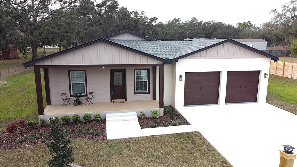 a front view of house with yard outdoor seating and barbeque oven