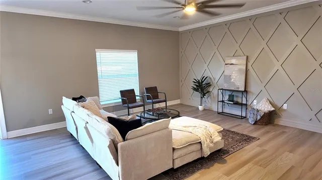 a living room with furniture and a large window