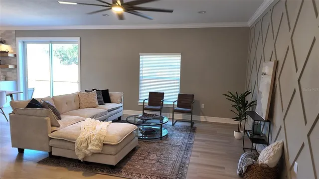 a kitchen with stainless steel appliances kitchen island granite countertop a sink dishwasher a refrigerator and cabinets with wooden floor