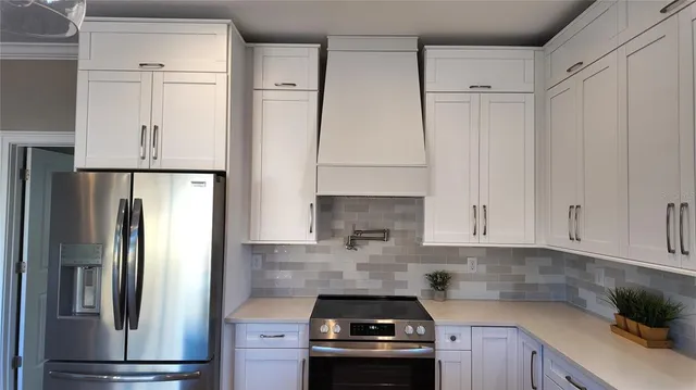 a kitchen with white cabinets and a sink
