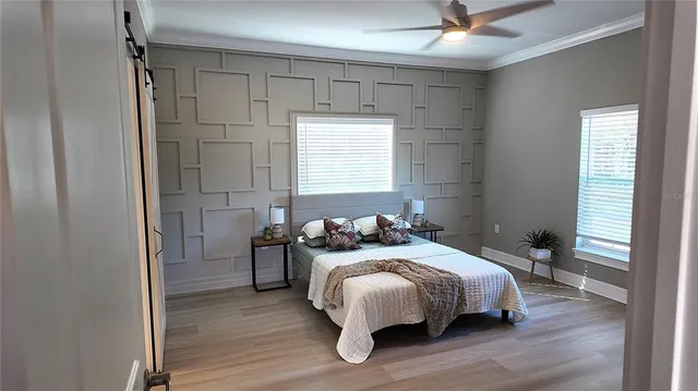 a bedroom with a bed and wooden floor