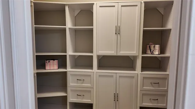 a reading room with wooden floor and a window