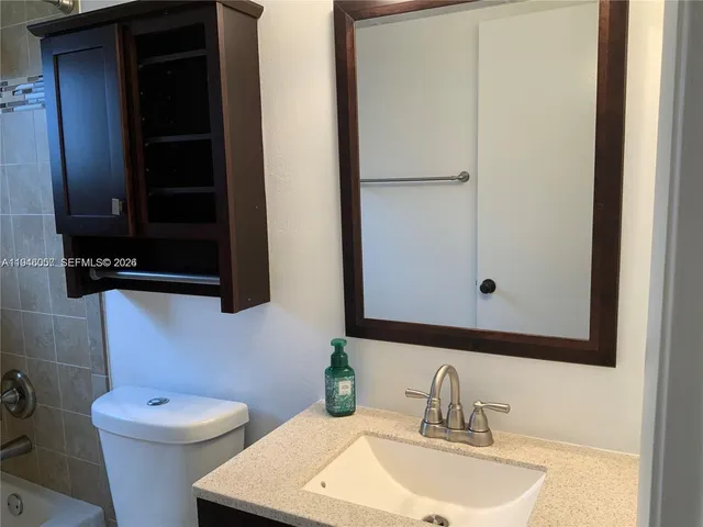 a bathroom with a sink a toilet and bathtub